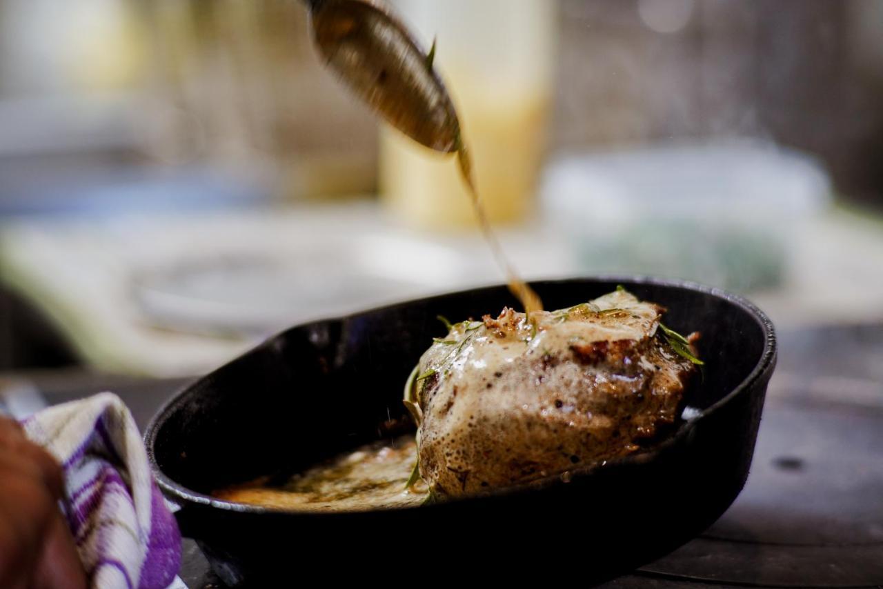 Parehua Resort Martinborough Esterno foto A chef pouring sauce over a steak
